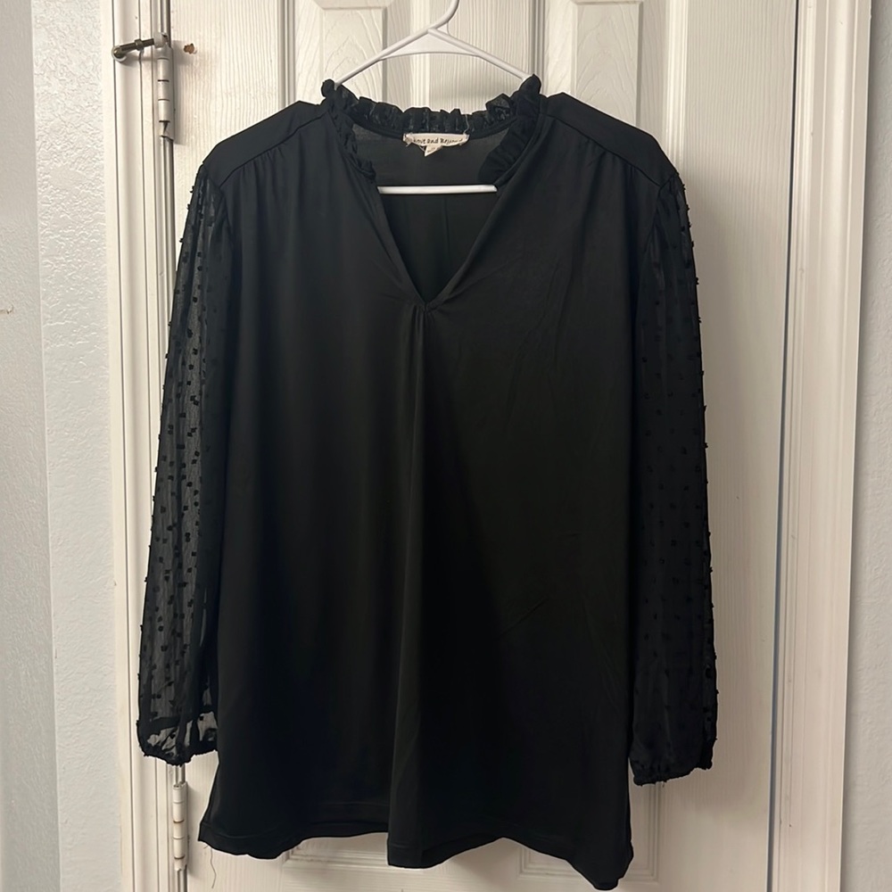 Black top with sheer, ruffled sleeves